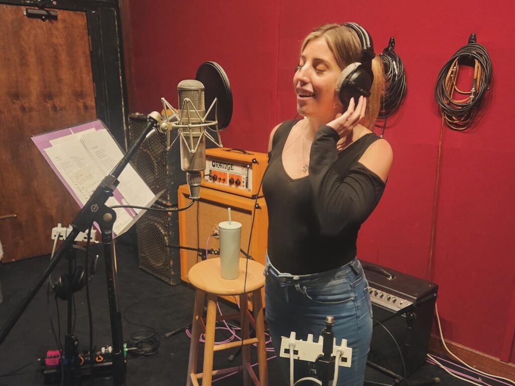 Candid photo of therapist Andrea Santiago in a recording booth, showing creativity, expression, and authenticity