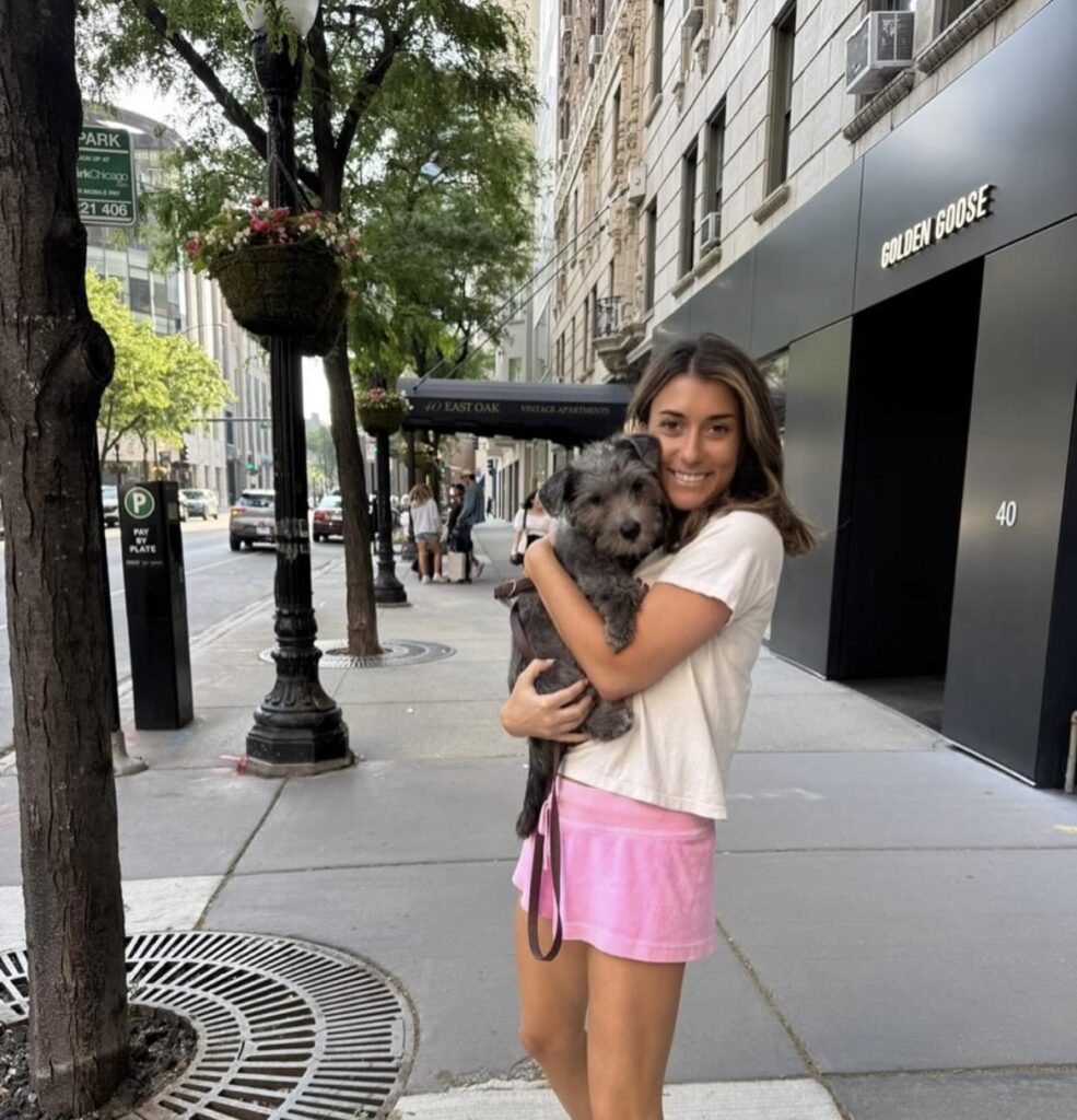 Our therapist Jane Sussman holding her puppy, Ramona, on a sidewalk in Chicago