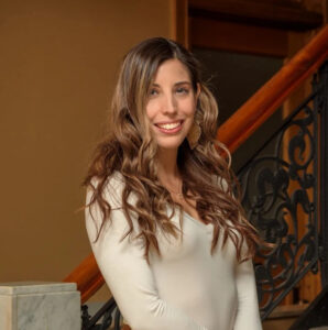 Headshot of Andrea Santiago Chicago therapist with brown hair smiling warmly