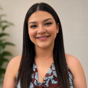 Maty Patino Trejo Chicago therapist with long dark hair smiling warmly at camera