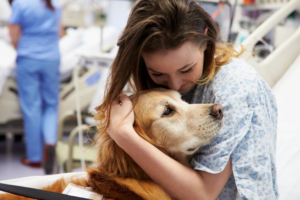 woman hugging golden retriever